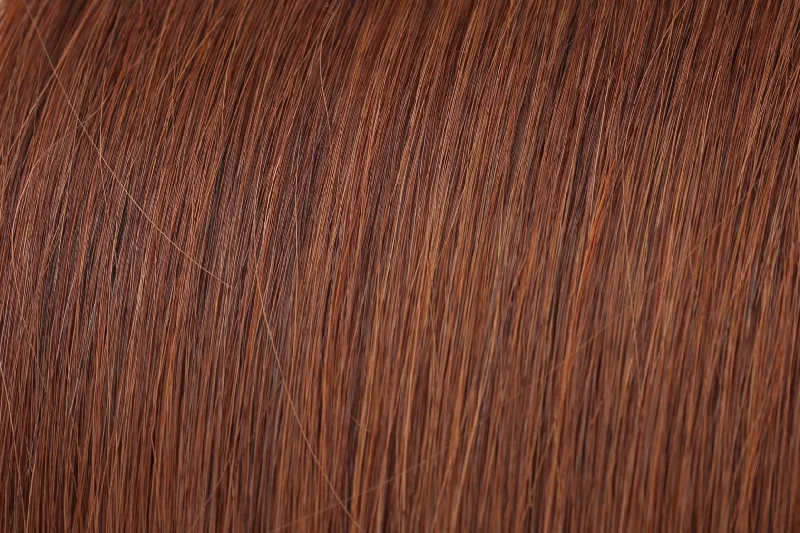 Clip - in hair extensions with a curly texture for a bold and stylish choiceSeamless Clip-In Extensions: Deep Copper #33