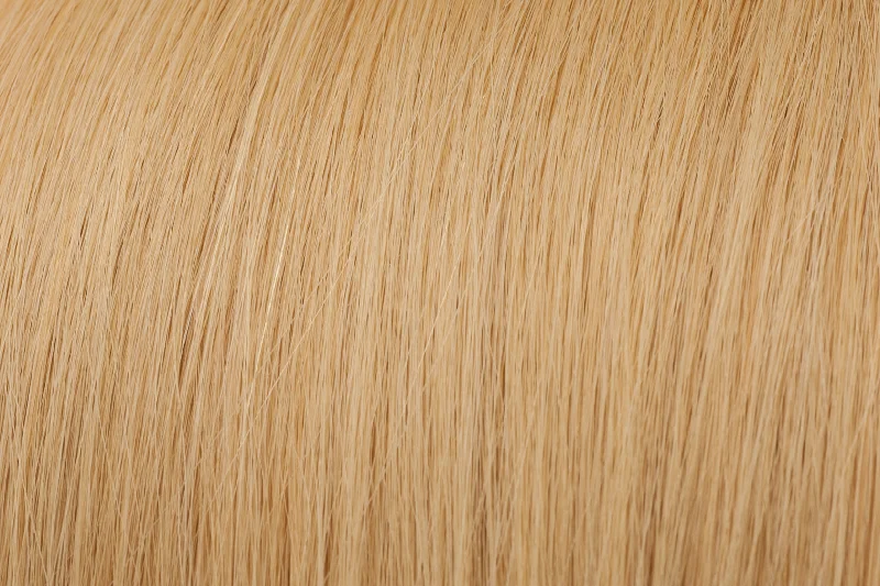 Clip - in hair extensions with a curly texture for a bold and stylish choiceSeamless Clip-In Extensions: Sandy Blonde #14